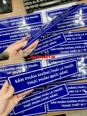 In bảng tên kệ tủ nhà thuốc Sản phẩm không phải là... , in UV thuận Mica xanh 5li cắt hình chữ nhật - INKTS3345