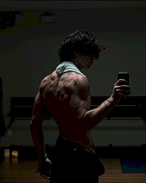 Cách chụp ảnh gym trước gương cho nam khoe bờ vai rộng, cơ bắp cuồn cuộn với dáng đứng hơi quay lưng. 