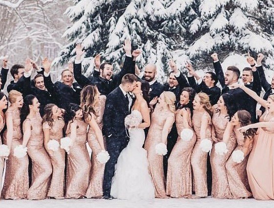 Cách tạo dáng đẹp khi đi đám cưới bằng cách xếp thành 2 hàng với 1 hàng trước là nữ còn hàng sau là nam, cô dâu chú rể đứng giữa hàng trước đang trao nhau nụ hôn, mọi người xung quanh la hét cổ vũ với các biểu cảm hài hước.