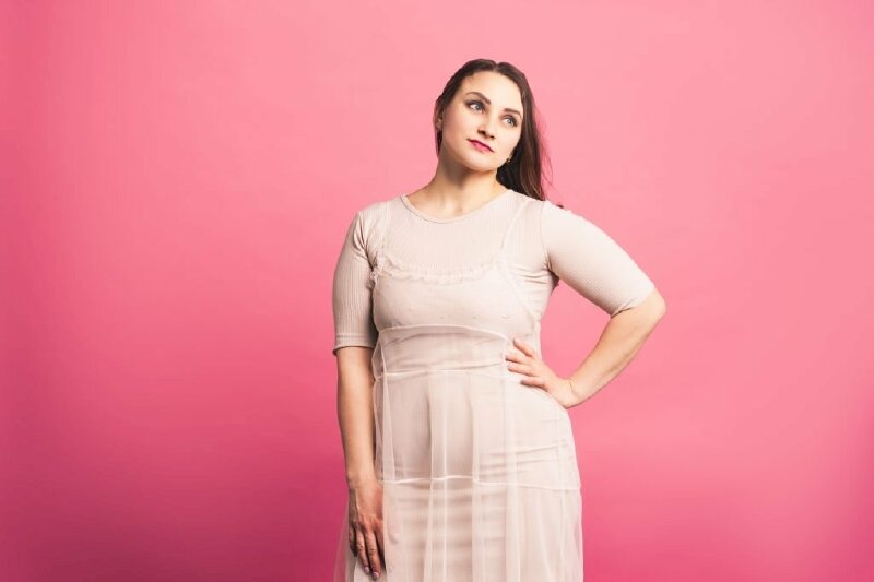 Kiểu tạo dáng chụp ảnh cho người có bắp chân to với góc chân nửa người, một tay chống hông, đầu hơi nghiêng, mắt nhìn hướng lên