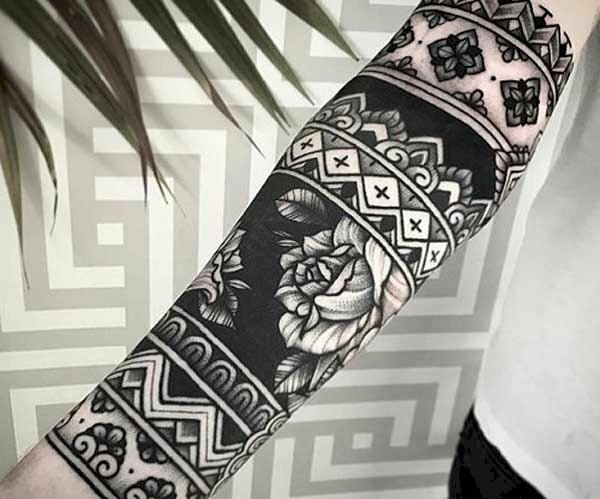 Hình xăm đen trắng hoa văn và hoa ở cánh tay