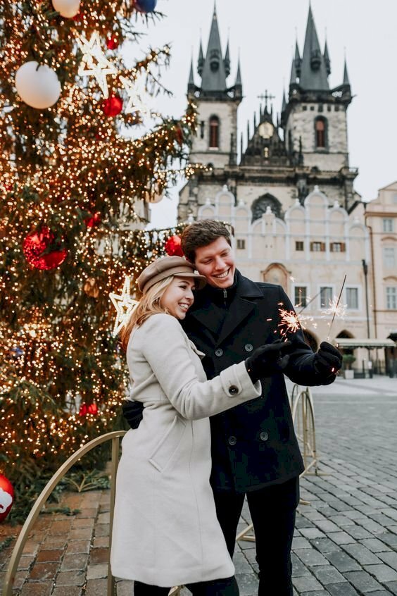 Tạo dáng đôi tình nhân đang chơi pháo hoa rất tự nhiên trong dáng đứng thẳng, đầu bạn nữ hơi nghiêng, miệng cười tươi