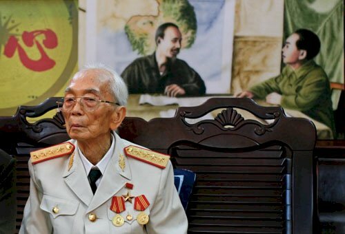 Đại tướng Võ Nguyên Giáp trước một bức tranh của mình và Chủ tịch Hồ Chí Minh tại nhà riêng ở Hà Nội vào ngày sinh nhật thứ 97 vào ngày 25-8-2008