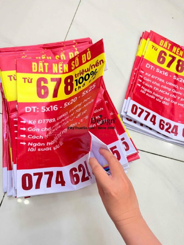 In băng rôn bán đất nền sổ đỏ kèm thông tin và số hotline môi giới bất động sản, in bạt hiflex xỏ cây trên dưới - INKTS2225