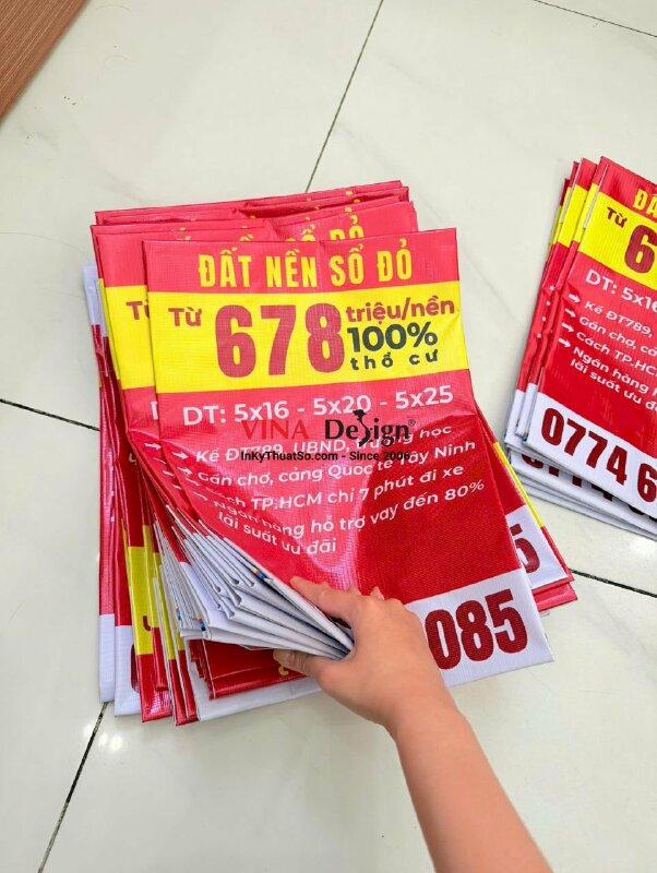 In băng rôn bán đất nền sổ đỏ kèm thông tin và số hotline môi giới bất động sản, in bạt hiflex xỏ cây trên dưới - INKTS2225